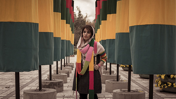 An unexpected background complements this young girl's colorful expression. Tehran, Iran