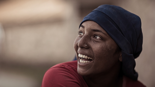 A young woman doing heavy work in the construction of a house. Pokhara, Nepal