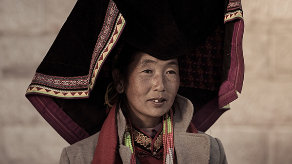 Portrait of a Yi tribal woman in traditional clothing. Yunnan Province, China